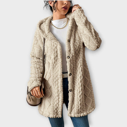 Woman wearing textured hooded winter jacket with relaxed fit