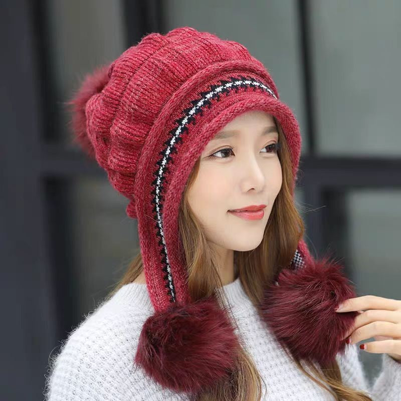 Women's knit beanie with ear flaps and pompom