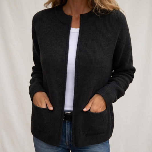 Woman wearing ribbed open front cardigan with front pockets