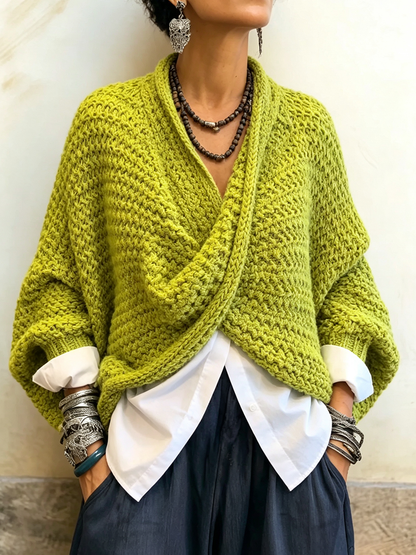 Woman wearing batwing crossover V-neck sweater indoors