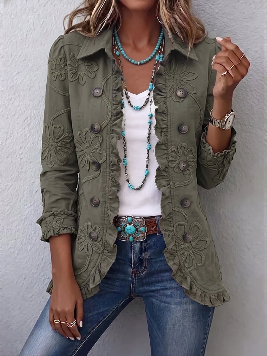 Woman wearing green floral embroidered jacket with ruffle trim