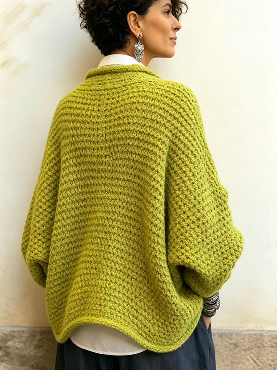 Woman wearing batwing crossover V-neck sweater indoors