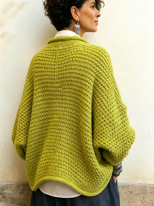 Woman wearing batwing crossover V-neck sweater indoors