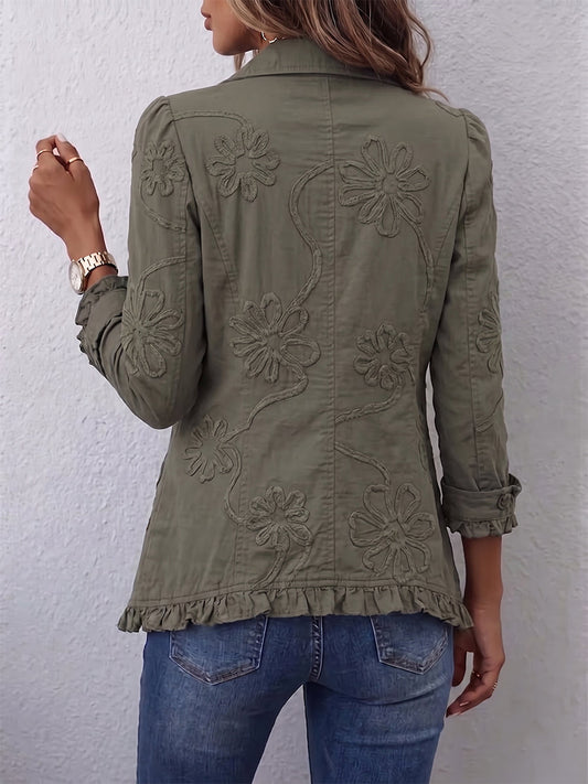 Woman wearing green floral embroidered jacket with ruffle trim