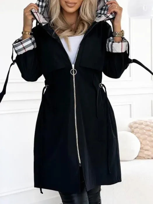 Woman wearing long coat with plaid hood